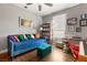 Comfortable bedroom with a blue daybed, desk, and a bookcase, perfect for a cozy and productive space at 23 Cerchio Basso, Henderson, NV 89011