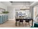 Elegant dining area with stylish chandelier and a seamless flow into the well-equipped kitchen at 23 Cerchio Basso, Henderson, NV 89011