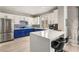 Modern kitchen with an island, white cabinetry, stylish backsplash, and breakfast bar at 23 Cerchio Basso, Henderson, NV 89011
