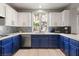 Bright kitchen with two-tone cabinetry, stainless steel appliances, and backyard views at 23 Cerchio Basso, Henderson, NV 89011