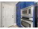 Modern kitchen features stainless steel microwave and oven combo, adjacent to a doorway at 23 Cerchio Basso, Henderson, NV 89011