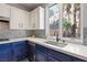 Inviting kitchen with white countertops, blue cabinetry, and backyard views at 23 Cerchio Basso, Henderson, NV 89011