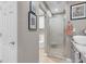 Modern bathroom with gray walls, granite counters, shower with glass door, and white door at 2508 Palmridge Dr, Las Vegas, NV 89134
