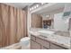 Bathroom with granite countertops, neutral brown shower curtain, and bright lighting at 2508 Palmridge Dr, Las Vegas, NV 89134