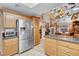 Open kitchen with stainless steel appliances and a view into the dining room at 2508 Palmridge Dr, Las Vegas, NV 89134