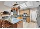 Well lit kitchen with stainless steel appliances, wood cabinets, and tile flooring at 2508 Palmridge Dr, Las Vegas, NV 89134