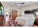 Bright main bedroom featuring hardwood floors, ceiling fan, and a patterned rug at 2508 Palmridge Dr, Las Vegas, NV 89134