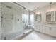 Stunning bathroom showcases a large glass shower with mosaic tile and double vanity with modern fixtures at 2581 Terrytown Ave, Henderson, NV 89052