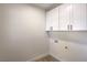 Clean laundry room with white cabinets providing ample storage space at 2581 Terrytown Ave, Henderson, NV 89052