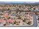 Aerial view of a residential area with well-maintained homes, lush landscaping, and picturesque mountain views at 2608 Saltbush Dr, Las Vegas, NV 89134