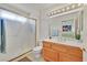 Bathroom features a shower with a gold frame, vanity with double sinks, and modern lighting at 2608 Saltbush Dr, Las Vegas, NV 89134