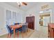 Bright dining area featuring a wooden table, blue chairs, and ample natural light from shuttered windows at 2608 Saltbush Dr, Las Vegas, NV 89134