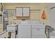 Practical laundry room equipped with a washer, dryer, sink, and ample storage space at 2608 Saltbush Dr, Las Vegas, NV 89134