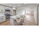 Bright, open kitchen featuring stainless steel appliances, white cabinets, and a center island with seating at 2621 Bello Dr, North Las Vegas, NV 89030