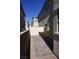 Narrow backyard area, partially paved with gravel at 2765 Frosted Teal Ave, North Las Vegas, NV 89086