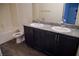 Bathroom with a double vanity, granite counters, and wood look tile at 2765 Frosted Teal Ave, North Las Vegas, NV 89086