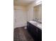 Full bathroom featuring wood-look floors, double vanity with granite counters, and a shower-tub combo at 2765 Frosted Teal Ave, North Las Vegas, NV 89086