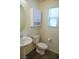 Powder room with a pedestal sink, wood-look flooring, and a window that provides natural light at 2765 Frosted Teal Ave, North Las Vegas, NV 89086