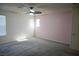 Bright bedroom with ceiling fan, neutral carpet, and dual windows at 2765 Frosted Teal Ave, North Las Vegas, NV 89086