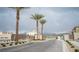 Gated community entrance featuring palm trees and a paved road at 2765 Frosted Teal Ave, North Las Vegas, NV 89086