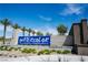 Watercolor planned community entrance sign with palm trees under a sunny blue sky at 2765 Frosted Teal Ave, North Las Vegas, NV 89086