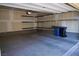 Two car garage with concrete floors and shelving at 2765 Frosted Teal Ave, North Las Vegas, NV 89086
