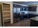 Modern kitchen features stainless steel appliances, granite counters, and dark wood cabinets at 2765 Frosted Teal Ave, North Las Vegas, NV 89086
