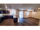 Living room and kitchen combination featuring granite countertops and dark wood flooring at 2765 Frosted Teal Ave, North Las Vegas, NV 89086