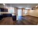 Living room and kitchen combination featuring granite countertops and dark wood flooring at 2765 Frosted Teal Ave, North Las Vegas, NV 89086
