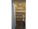 Walk-in pantry featuring modern wood flooring and custom shelving at 2765 Frosted Teal Ave, North Las Vegas, NV 89086