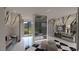 Spa-like bathroom with marble walls, soaking tub, and modern fixtures offering a luxurious and serene retreat at 3 Climbing Canyon Dr, Henderson, NV 89052