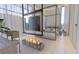 Modern bedroom with a unique fireplace, four-poster bed, and light-filled windows at 3 Climbing Canyon Dr, Henderson, NV 89052