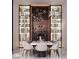 Chic dining room features elegant lighting, a decorative wine rack, and a modern table at 3 Climbing Canyon Dr, Henderson, NV 89052