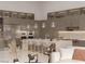 Modern kitchen boasts stainless steel appliances, stone countertops, and bar stool seating at 3 Climbing Canyon Dr, Henderson, NV 89052