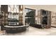 Stunning living room featuring a wet bar, and floor to ceiling windows with views of the manicured landscape at 3 Climbing Canyon Dr, Henderson, NV 89052