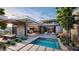 Modern outdoor space featuring a pool, sleek patio and outdoor dining, perfect for entertaining guests at 3 Climbing Canyon Dr, Henderson, NV 89052
