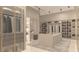 Spacious walk-in closet with custom shelving and glass-front cabinets for optimal organization at 3 Climbing Canyon Dr, Henderson, NV 89052