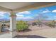 Charming covered patio features decorative pillars and a landscaped backyard with mountain views at 3042 Lake Barkley Rd, Henderson, NV 89052