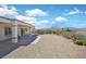 Expansive backyard has gravel landscaping, mature bushes, and a covered patio perfect for outdoor relaxation at 3042 Lake Barkley Rd, Henderson, NV 89052