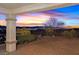 Backyard showcasing stunning sunset views, landscaping and a comfortable outdoor living space at 3042 Lake Barkley Rd, Henderson, NV 89052