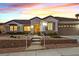 Inviting single-story home featuring landscaped front yard and a two-car garage at dusk at 3042 Lake Barkley Rd, Henderson, NV 89052