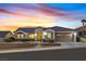 Charming single-story home with a well-manicured front yard and a two-car garage under a lovely sunset at 3042 Lake Barkley Rd, Henderson, NV 89052
