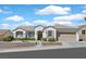 Inviting one-story home features a well-maintained front yard, a beige exterior, and an attached garage at 3042 Lake Barkley Rd, Henderson, NV 89052