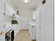 Well-organized laundry room featuring ample cabinet space and modern appliances, perfect for household chores at 3042 Lake Barkley Rd, Henderson, NV 89052