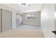 Bright carpeted bedroom featuring neutral walls, a window with bars, and a sliding door closet at 3119 Desmond Ave, Las Vegas, NV 89121