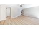 A bright, spacious bedroom with wood-look flooring, a modern light fixture, and an open closet at 3119 Desmond Ave, Las Vegas, NV 89121