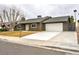 Single-story home featuring desert landscaping, a long driveway, and a two-car garage at 3119 Desmond Ave, Las Vegas, NV 89121