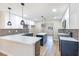 Modern kitchen features white cabinets, a center island and stainless steel appliances at 3119 Desmond Ave, Las Vegas, NV 89121