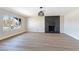 Bright living room featuring new flooring, fireplace and a large window at 3119 Desmond Ave, Las Vegas, NV 89121