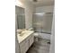 Neutral bathroom with vanity and shower-tub combo with sliding glass door at 3422 Pino Cir, Las Vegas, NV 89121